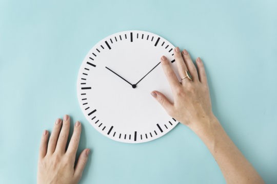 A clock with a lady鈥檚 hand moving the hands