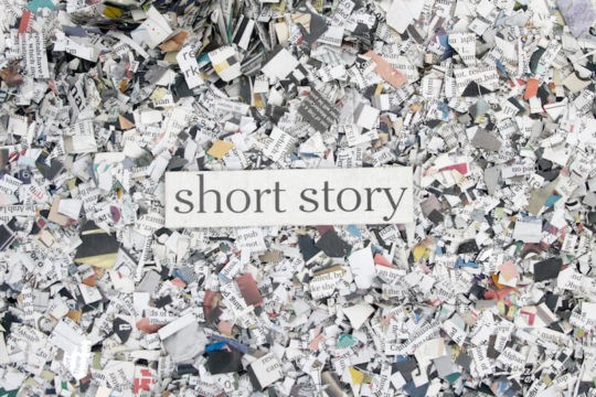 Book confetti shown from above with the text 鈥渟hort story鈥� written over it.